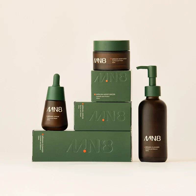 MN8 Full-Spectrum Mānuka Bundle — cleanser, serum and moisturizer with green gift boxes on cream background